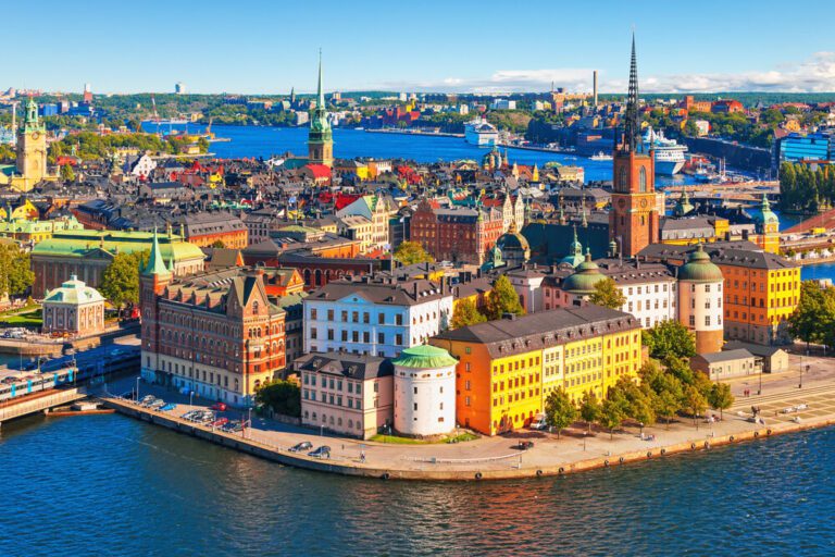 An-aerial-photograph-of-Stockholm-Sweden-showing-dozens-of-large-3-and-4-story-buildings-in-classical-architectural-styles-surrounded-by-a-large-river-768x512(1)
