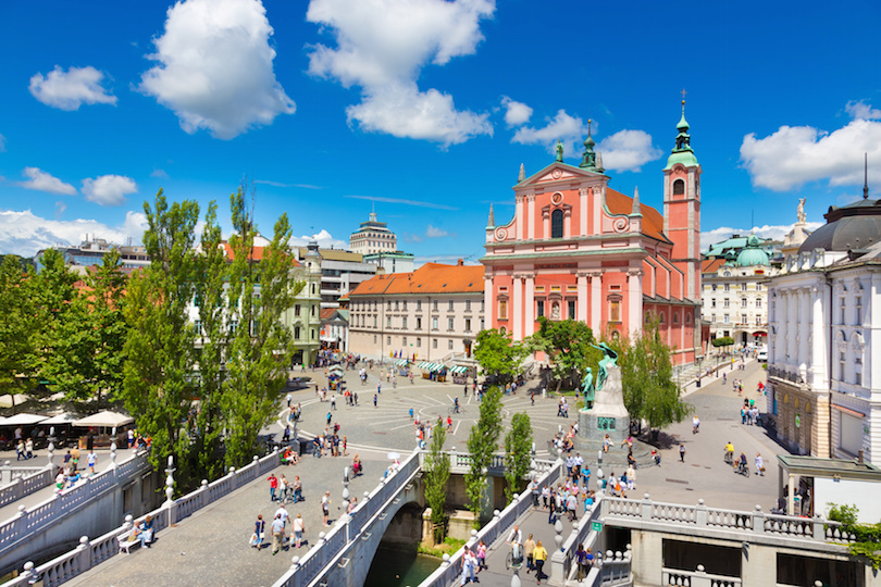 Romantic Ljubljana city center: river Ljubljanica, Triple Bridge (Tromostovje), Preseren square and Franciscan Church of the Annunciation; Ljubljana, Slovenia, Europe.